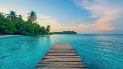 Poster - Wooden dock extending into clear blue water towards a tropical island with lush greenery and sandy beach