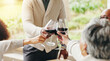 © peopleimages.com - Family, toast and outdoor hands for celebration on vacation, easter lunch and proud to connect. People, cheers and sharing traditional holiday in home backyard, social gathering and patio party