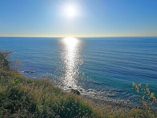 Wall Mural - coastal sunrise sun reflecting ocean clifftop