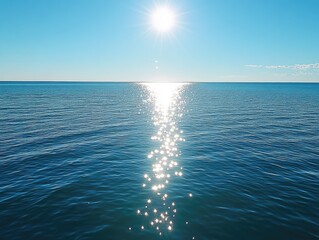 Wall Mural - sun's reflection on calm ocean, clear sky