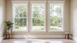© Selvi - Sunlight Streams Through Large Triple Windows in a Room with Hardwood Floors and Plants, Illuminating the Space Brightly.