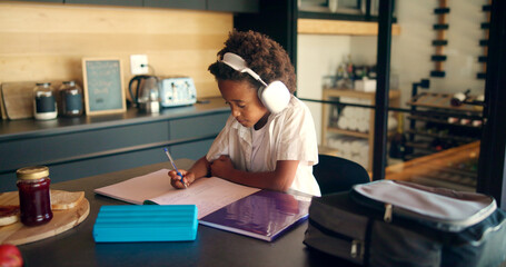 Poster - Child, writing and headphones for education in home, homework and student listening to audio. Boy, notebook lesson and elearning podcast for studying, language project and kid for mind development