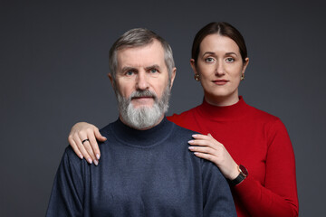 Wall Mural - Family portrait of daughter and her father on dark background