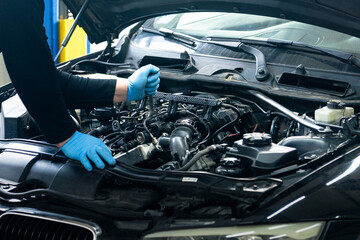 Poster - Serviceman repair car in car service