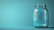 © Ganz - Minimalist image of an empty glass jar with a metal lid set against a gradient blue backdrop, ideal for storage, canning, and DIY projects