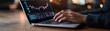 © Kassiopeia  - A trader intently analyzes glowing market trends on a sleek laptop screen in a vibrant trading environment, making strategic investment choices