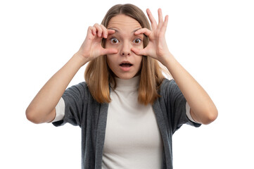 Wall Mural - A surprised young woman with hands on her face, making a playful expression against a white background.