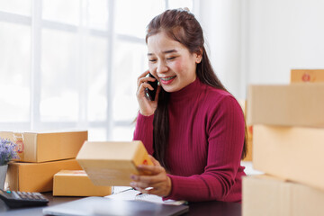 Startup small business entrepreneur SME, asian woman receive order on phone. Portrait young Asian small business owner home office, online sell marketing delivery, SME e-commerce telemarketing concept