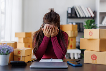 Small Business, Startup SME, Owner Entrepreneurs. Asian woman with unsuccess business online shopping crying and serious face unhappy mood,SME telemarket bankrupt stress concept.