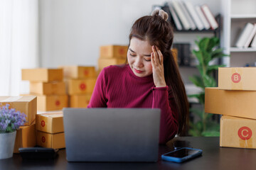 Small Business, Startup SME, Owner Entrepreneurs. Asian woman with unsuccess business online shopping crying and serious face unhappy mood,SME telemarket bankrupt stress concept.