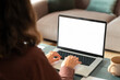© Stock 4 You - Over shoulder view of female freelancer business woman working remotely, looking at white blank mockup laptop pc screen for advertising. Student doing ai search online for it work or studying at home