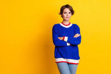 Poster - Photo portrait of pretty young girl crossed hands confident pose wear trendy blue knitwear outfit isolated on yellow color background