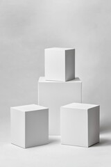Poster - Minimalist display of white geometric boxes on a soft gray background, ideal for showcasing products or creating a modern aesthetic.