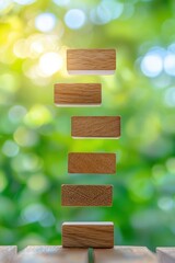 Poster - a creative arrangement of wooden blocks stacked vertically against a blurred green background, symbo