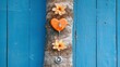 © Tung's companion - Heart-Shaped Medical Device with Flowers on Rustic Blue Wooden Background