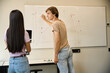 © Svitlana - Blond guy draws graphs on a whiteboard