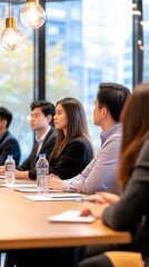 Poster - Group of professionals engaged in a meeting at a modern office with cityscape views outside
