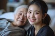 © ajan - Cheerful asian nurse smiling and covering a blanket to elderly in nursing home