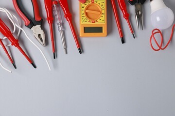 Poster - Different electrical tools on grey background, flat lay. Space for text