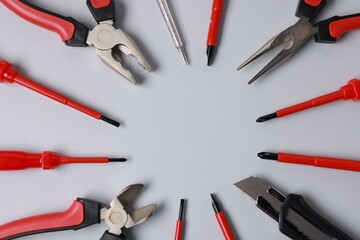 Poster - Frame of different electrical tools on grey background, flat lay. Space for text
