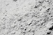 © AI_images_for_people - Close-up of volcanic ash texture, soft gray powder with tiny porous rock fragments.