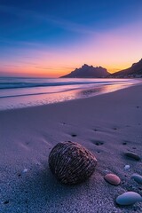 Poster - A single coconut sits on a sandy beach with mountains visible in the distance
