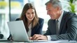 © Ева Поликарпова - A couple sitting together, looking at a laptop screen with interest