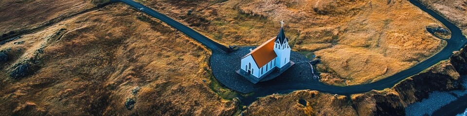 Poster - Aerial view of a small church situated on a hill, surrounded by greenery
