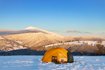 overnight in a tent in the mountains in winter, camping equipment.