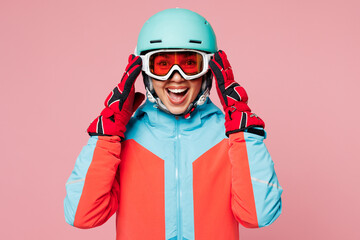 Poster - Snowboarder shocked surprised young woman wear blue padded jacket ski goggles mask helmet spend extreme weekend winter season in mountains look camera isolated on plain pink background. Hobby concept.