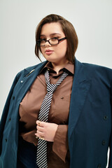 Wall Mural - Confident young plus size woman stylishly dressed in oversized jacket and glasses