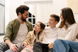 © Maria Vitkovska - Happy family spending time together at home, smiling and talking