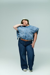 Wall Mural - Confident young plus size woman showcasing her unique denim style with grace and elegance