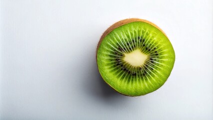 Poster - A vibrant, halved kiwi fruit on a pristine white background, showcasing its bright green flesh and tiny black seeds.