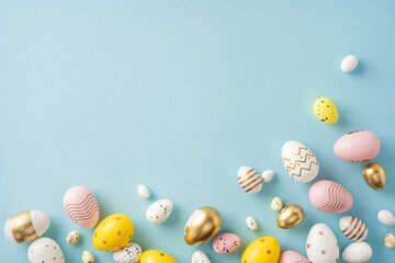 Wall Mural - assorted colored decorative easter eggs laid out on a light blue surface, with various patterns and 