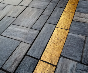 Poster - Golden Line Pavement: Abstract image of a gray stone pavement with a striking gold inlay creating a modern, elegant design.  The texture and contrast of the materials offers a unique visual interest.