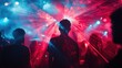 © CStock - A vibrant nightlife scene featuring silhouettes against colorful laser lights, capturing the energy and excitement of a live music event.