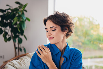 Photo of gentle tender cute girl dressed stylish clothes enjoying fresh smell indoors