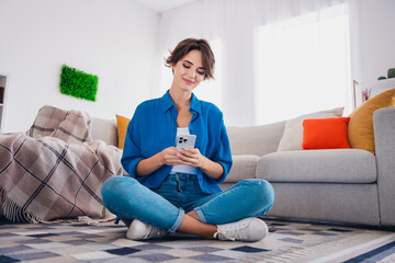 Poster - Photo of lovely charming cute girl sitting on floor in living room reading instagram telegram news alone indoors