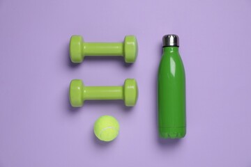 Wall Mural - Water bottle, tennis ball and dumbbells on violet background, flat lay. Sports equipment