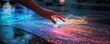 © Valentyna - Hand touching holographic projection on pavement, creating vibrant effect