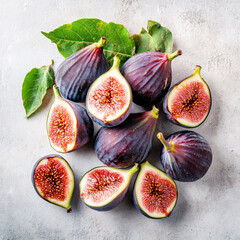 Canvas Print - Fresh figs, whole and halved, are arranged with green fig leaves on a textured, light-colored surface.