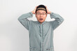 © AnnaJannah - Surprised Asian Muslim man Shocked gesture in Ramadan Eid Al Fitr and eid adha days celebration isolated white background. Islamic celebration concept..