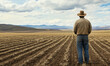 © Sekai - Contemplative farmer gazing over a vast barren field, embodying resilience and strength of rural life