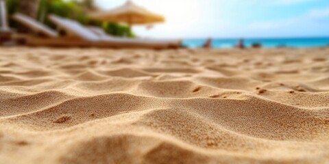 Wall Mural - Close-up of sandy beach with lounge chairs and umbrella in background