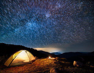 starry night camping spot with a lone tent under the vast universe, highlighting solitude.