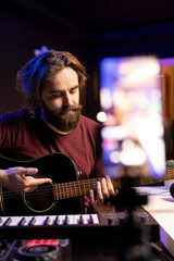 Poster - Professional singer teaching guitar lessons online on social media channel, recording himself playing acoustic instrument accords and explaining notes on strings. Young artist making tutorials.
