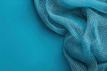 Poster - Bright blue fishing net draped over vibrant turquoise background in studio setting