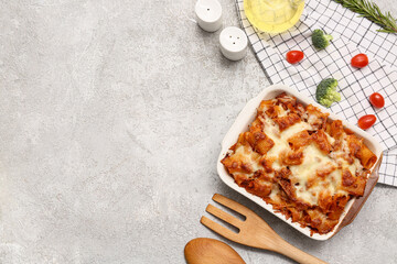 Canvas Print - Baking dish with tasty pasta, tomatoes and broccoli on grey grunge background