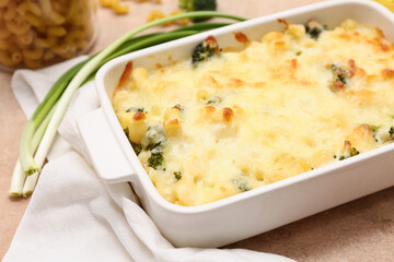 Wall Mural - Baking dish with tasty pasta, broccoli and green onion, closeup